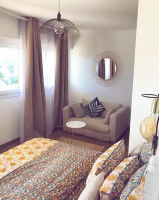 a living room with a bed and a couch at Duplex vue mer in Sagone
