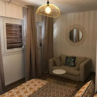 a living room with a couch and a mirror at Duplex vue mer in Sagone