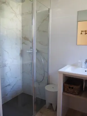 a bathroom with a shower and a toilet and a sink at Songes d’été in Bonifacio
