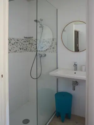 a bathroom with a shower and a sink at Songes d’été in Bonifacio