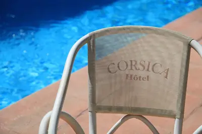 a chair sitting in front of a swimming pool at Hotel Corsica - Porto Corse in Porto Ota