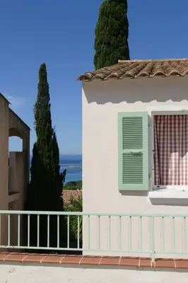 a chair and a potted plant on a porch at Residenza l 'Alivetu in Cargèse