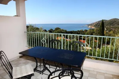 a living room with a black table and a couch at Residenza l 'Alivetu in Cargèse