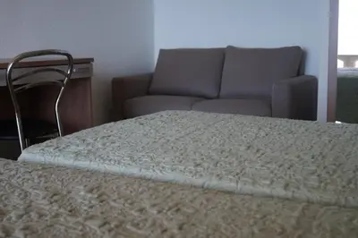 a bed in a room with a couch at L'Allegria in Casaglione