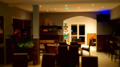 a living room with a couch and a table and chairs at L'Allegria in Casaglione