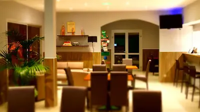 a living room with chairs and a dining room at L'Allegria in Casaglione