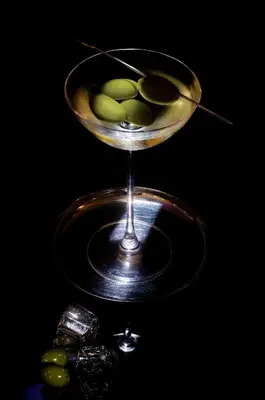 a martini glass with green olives in it at Hotel & SPA des Pecheurs in Bonifacio