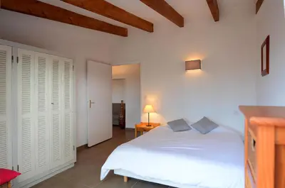 a bedroom with a white bed in a room at Residence les Bell'ombres in Cargèse