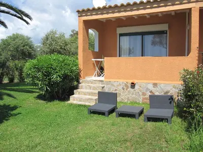 two chairs in front of a house at Residence les Bell'ombres in Cargèse
