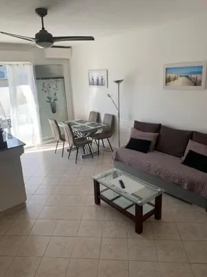 a living room with a couch and a table at Sables de biguglia cordon lagunaire in Borgo