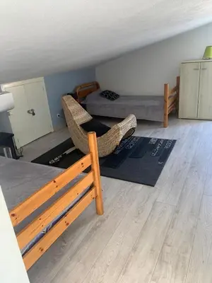 a room with a bed and a couch and a bed at Sables de biguglia cordon lagunaire in Borgo