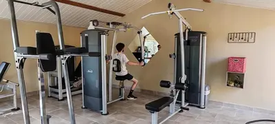 a man exercising in a gym with a mirror at Camping Kévano Plage in Pianottoli-Caldarello