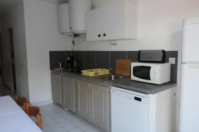 a kitchen with a sink and a microwave on a counter at Domaine Bocca di Feno in Bonifacio