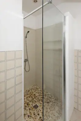 a shower with a glass door in a bathroom at Domaine Bocca di Feno in Bonifacio