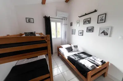 a bedroom with two bunk beds and a window at Vista Mare in Porticcio