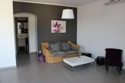 a living room with a couch and a coffee table at Les Orangers in Aléria