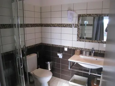 a bathroom with a toilet and a sink at Les Orangers in Aléria