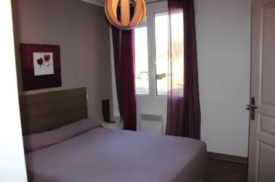 a bedroom with a bed and a window at Les Orangers in Aléria