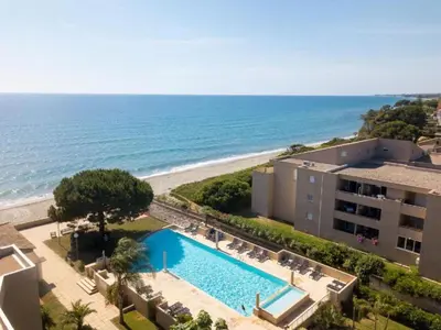 an aerial view of a resort with a swimming pool and the beach at Apartment MB4 Loggia by Interhome in Moriani Plage