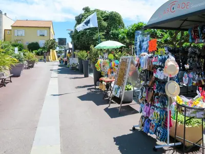 a street with a market with a rack of merchandise at Apartment MB4 Loggia by Interhome in Moriani Plage
