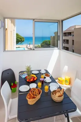 two beds in a room with a window at Apartment MB4 Loggia by Interhome in Moriani Plage