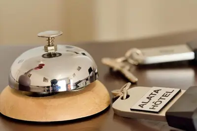 a clock sitting on a table next to a keys at Hotel Alata in Alata