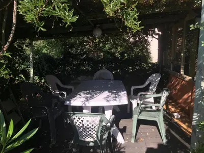 a table and chairs sitting under a pergola at U Parasu in Santa-Maria-Figaniella