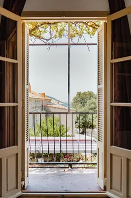 an open door to a balcony with a view at U Parasu in Santa-Maria-Figaniella