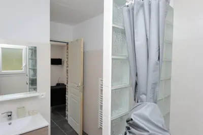 two images of a bathroom with a sink and a mirror at CHALET CANAVA in Bonifacio