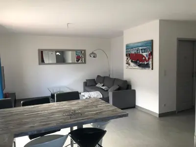 a living room with a table and a couch at Villa Orethaga Piscine 10 pers porto Vecchio in Porto-Vecchio