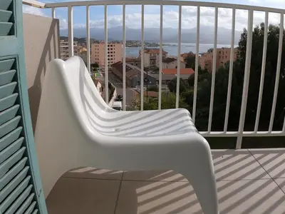 a white chair sitting on a balcony with a view at LA TERRASSE DE SAINT-JEAN in Ajaccio