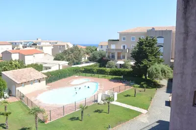 a view of a swimming pool in a city at PALMERAIE 325 in Sari Solenzara