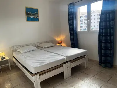 a bed sitting in a bedroom with a window at PALMERAIE 325 in Sari Solenzara