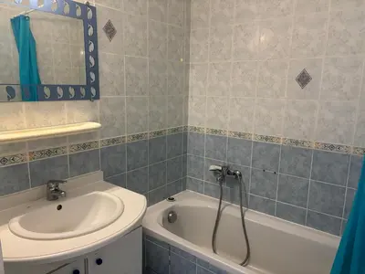 a bathroom with a sink and a bath tub at PALMERAIE 325 in Sari Solenzara