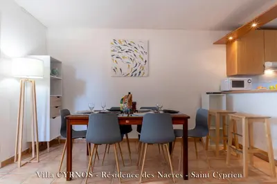 a kitchen with a dining room table and chairs at CYRNOS in Porto-Vecchio