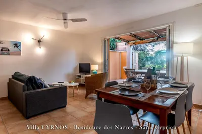 a dining room and living room with a dining table at CYRNOS in Porto-Vecchio