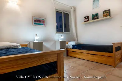a bedroom with two beds and a window at CYRNOS in Porto-Vecchio