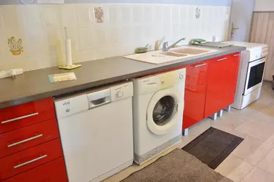a kitchen with a washing machine and a sink at FIUMICELLI in Sari Solenzara