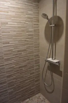 a shower with a shower head in a bathroom at FIUMICELLI in Sari Solenzara