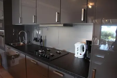 a kitchen with a black counter top and a sink at Résidence Ogliastrello in Olmeto
