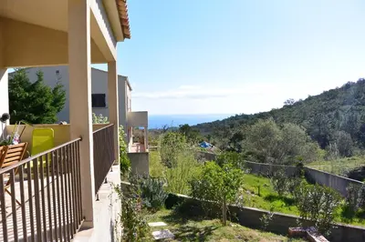 a balcony of a house with a view of the ocean at FILETTA in Sari Solenzara