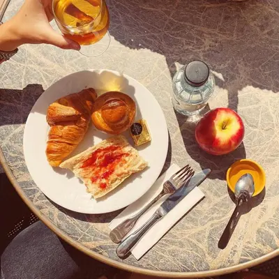 a plate of pastries and an apple on a table at Sun Beach in Ajaccio