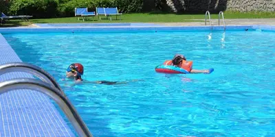 two girls playing in a swimming pool at Sun Beach in Ajaccio