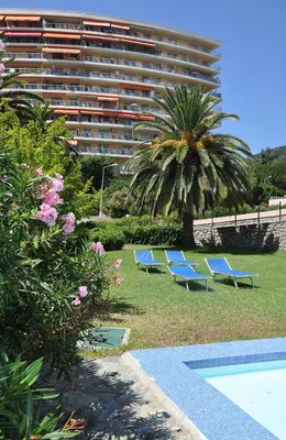 a group of blue benches in front of a building at Sun Beach in Ajaccio