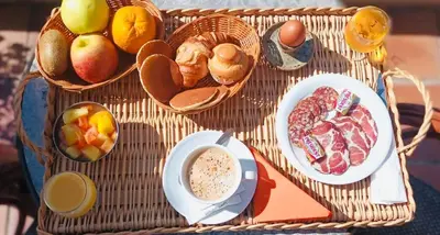 a table with baskets of food and a cup of coffee at Sun Beach in Ajaccio