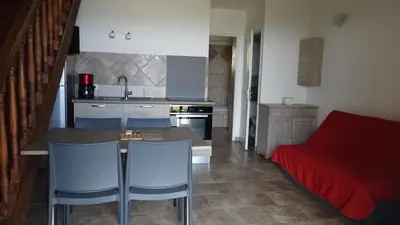 a kitchen with a table and chairs and a couch at Résidence Pascal Paoli Fior di Mare in Moriani Plage