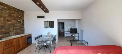 a bedroom with a bed and a table with chairs at Résidence Pascal Paoli Fior di Mare in Moriani Plage