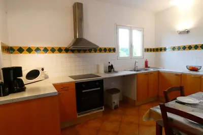 a kitchen with a sink and a stove at Résidence Pascal Paoli Fior di Mare in Moriani Plage