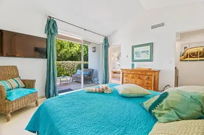 a bedroom with a bed with a blue comforter at A Casa Nostra in Coti-Chiavari