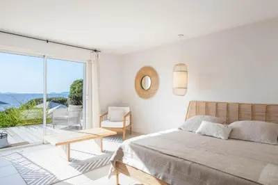 a bedroom with a bed and a large window at A Casa Nostra in Coti-Chiavari